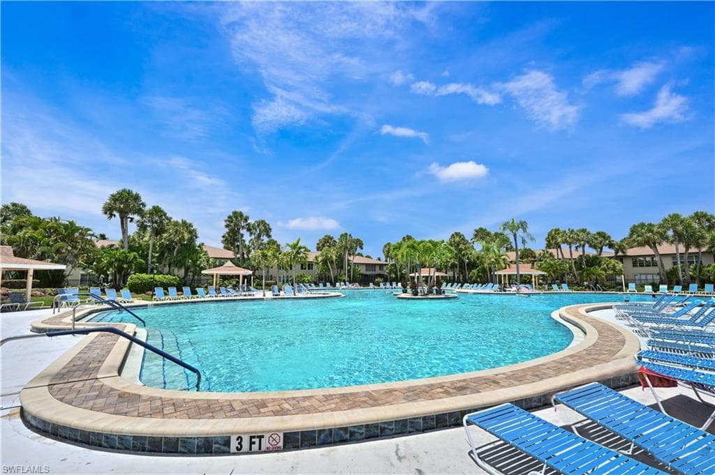 Community pool with a patio