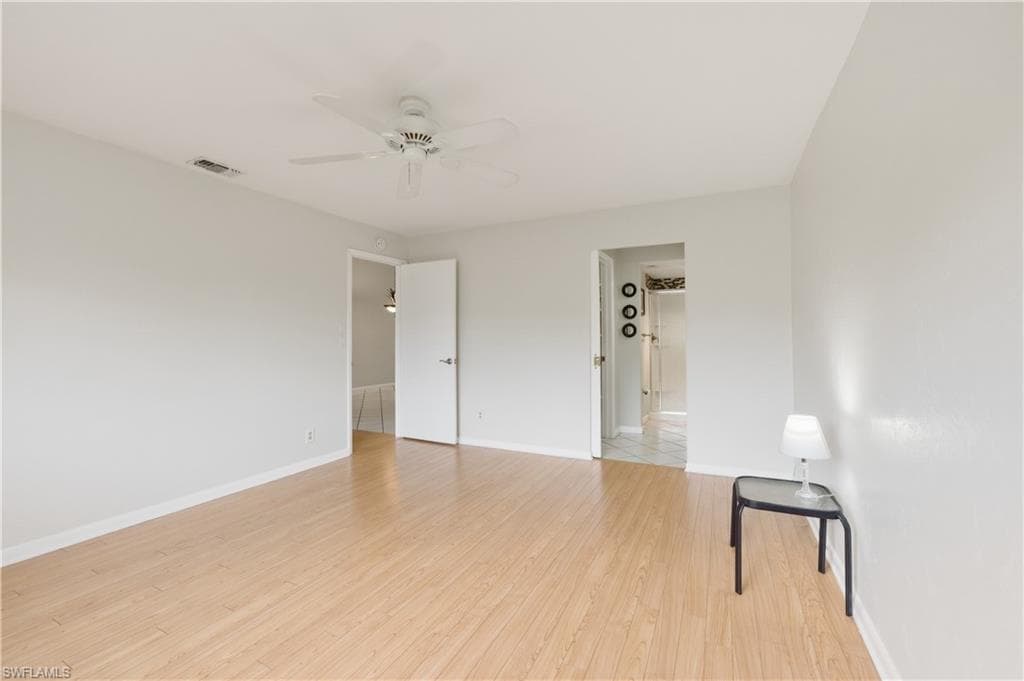 Master Bedroom with light wood-style flooring and ceiling fan