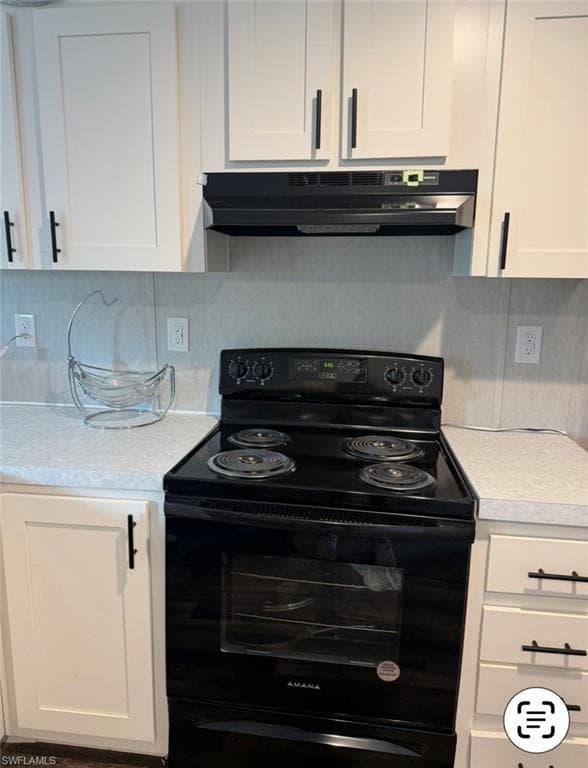 Kitchen with black range with electric stovetop, white cabinets, light countertops, and backsplash