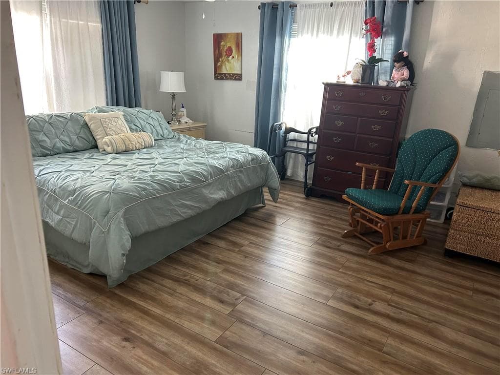 Bedroom featuring hardwood / wood-style flooring and electric panel