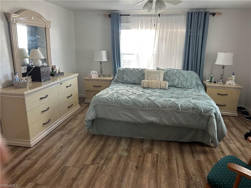 Bedroom featuring dark wood-style floors and ceiling fan
