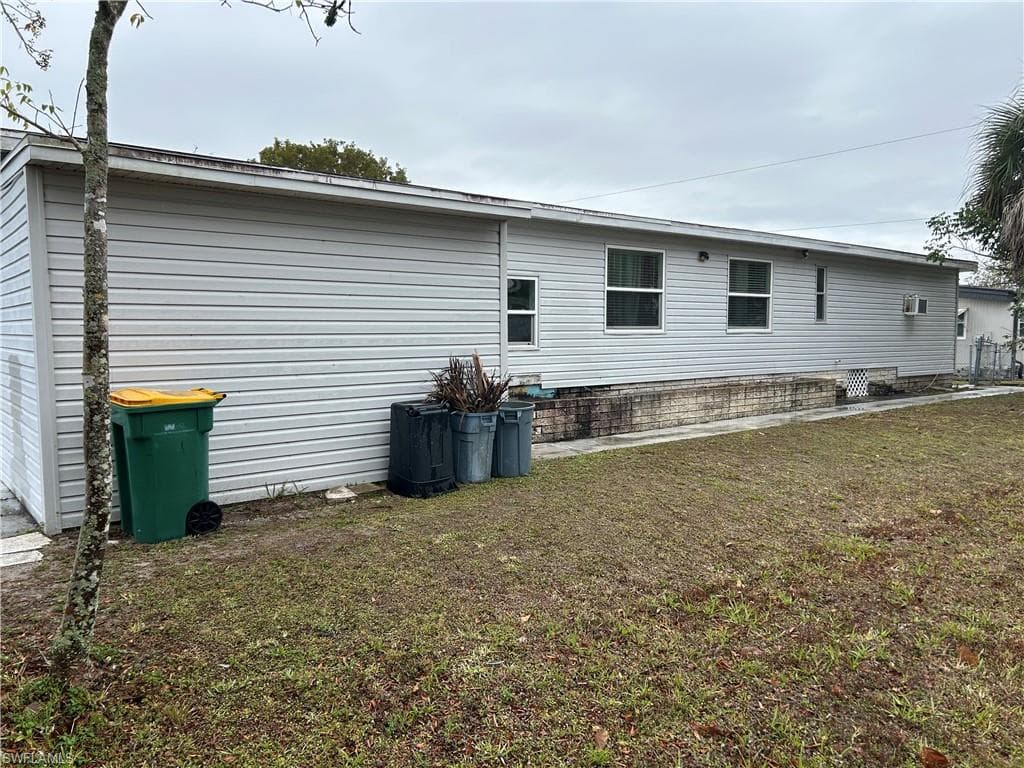 View of home's exterior with a lawn and a patio