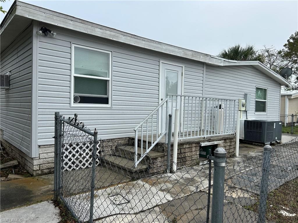 Rear view of property with a gate and a patio area