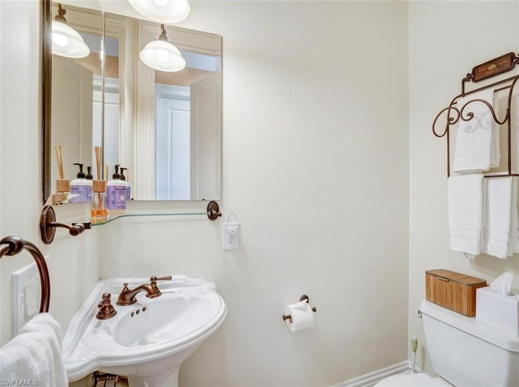 Bathroom with toilet and a sink - Virtually Edited Image