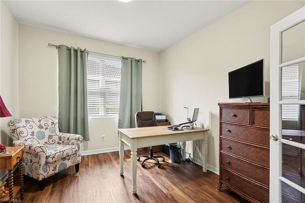 Office area with wood finished floors and baseboards