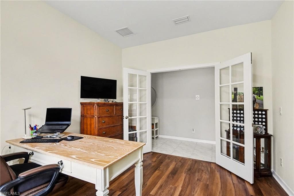 Home office featuring french doors and dark wood finished floors