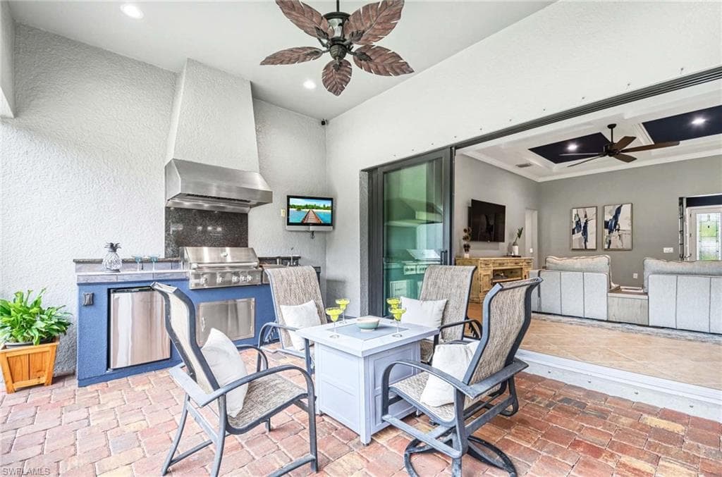 View of patio featuring an outdoor kitchen / dining area and a ceiling fan