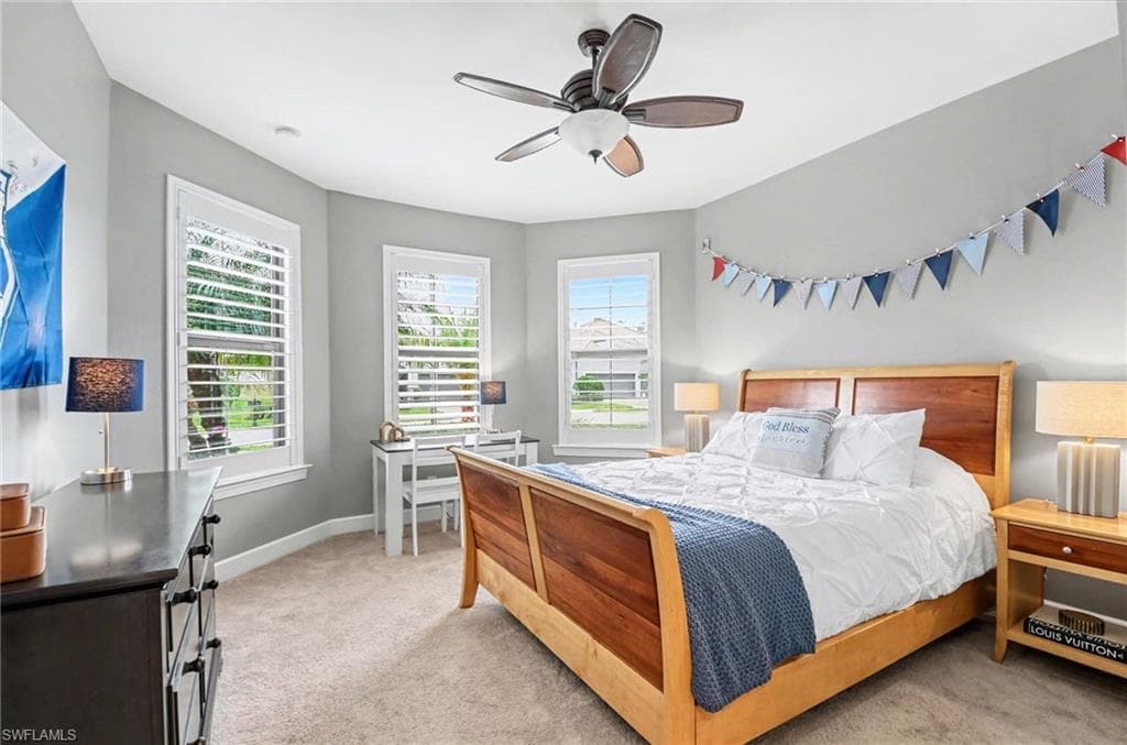 Bedroom featuring light carpet and a ceiling fan