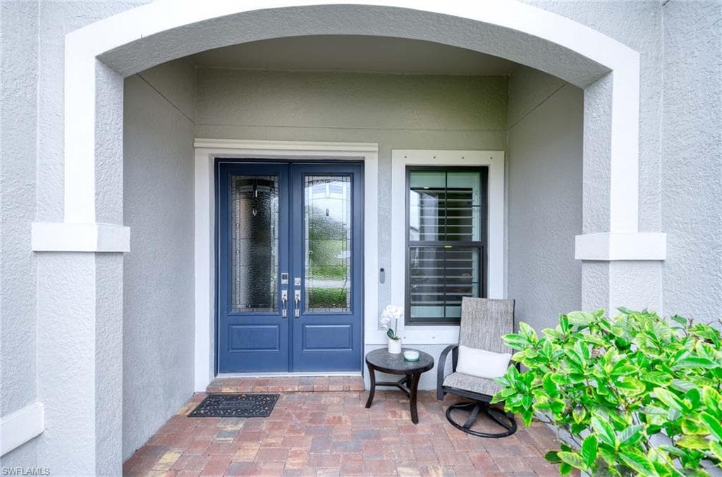 Doorway to property with french doors and stucco siding