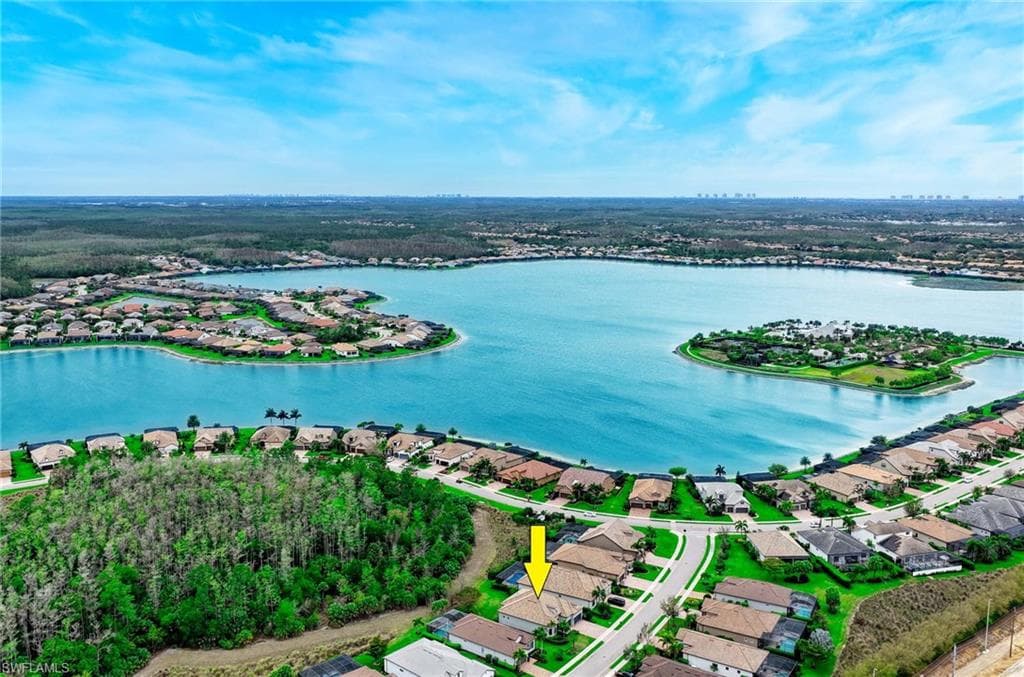 Aerial view of residential area featuring a nearby body of water