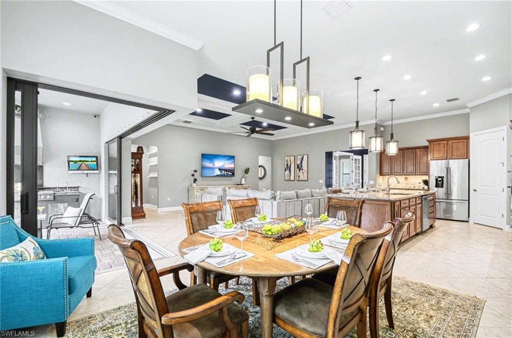 Dining room featuring recessed lighting, crown molding, and ceiling fan