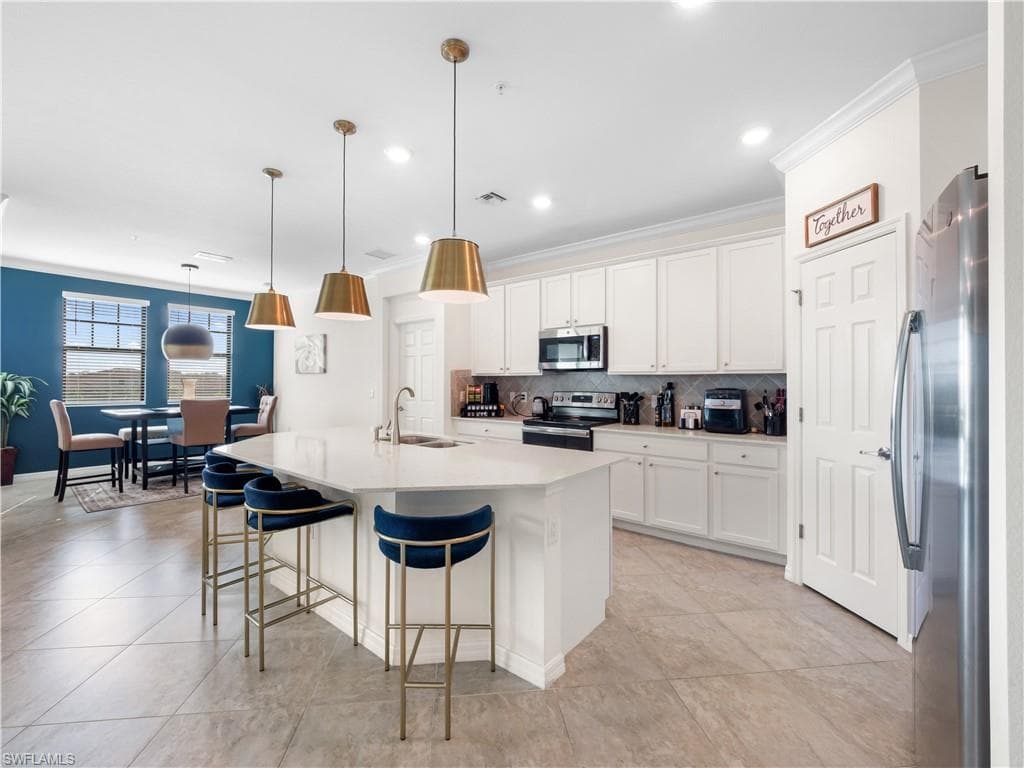 Living area featuring ornamental molding, recessed lighting, and ceiling fan