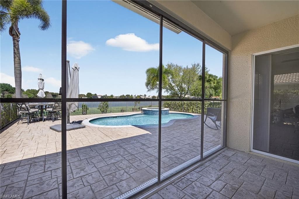 Covered screened in lanai and outdoor dining space.