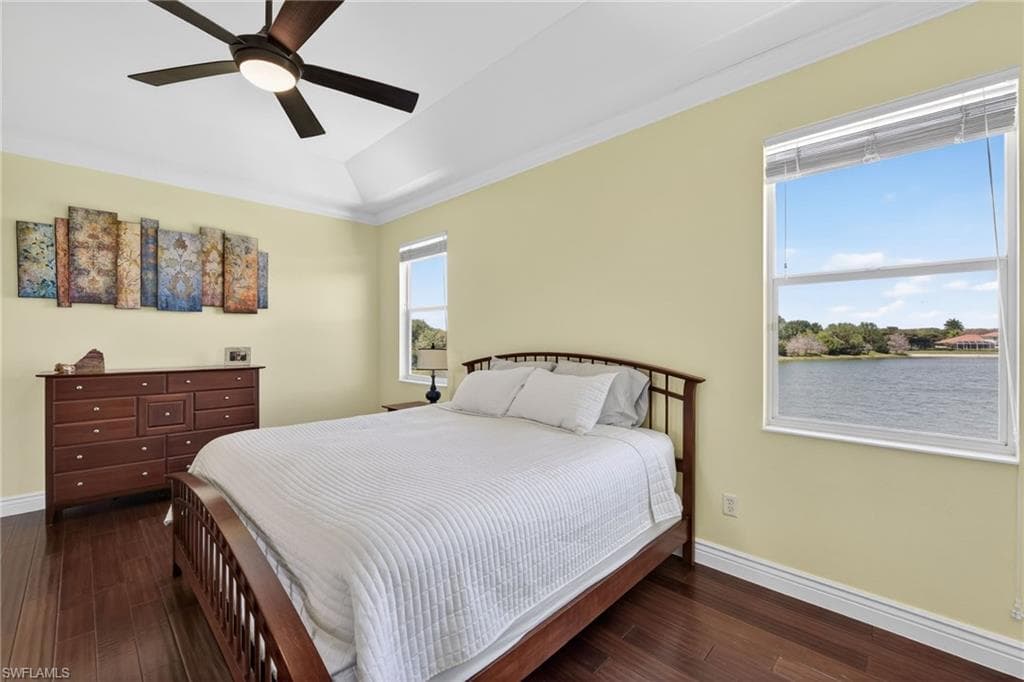 Bedroom featuring dark wood finished floors, a ceiling fan, and crown molding