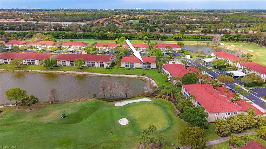 Drone / aerial view of a local golf course and a nearby body of water