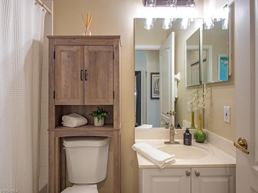 Full bath featuring vanity and shower / bath combo