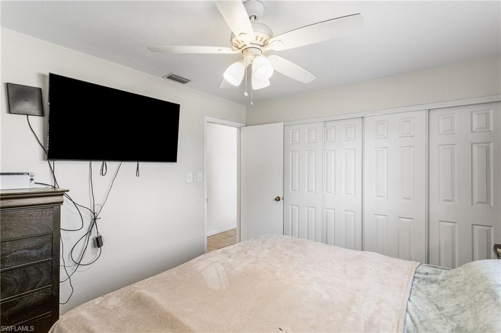 Bedroom with a ceiling fan and a closet