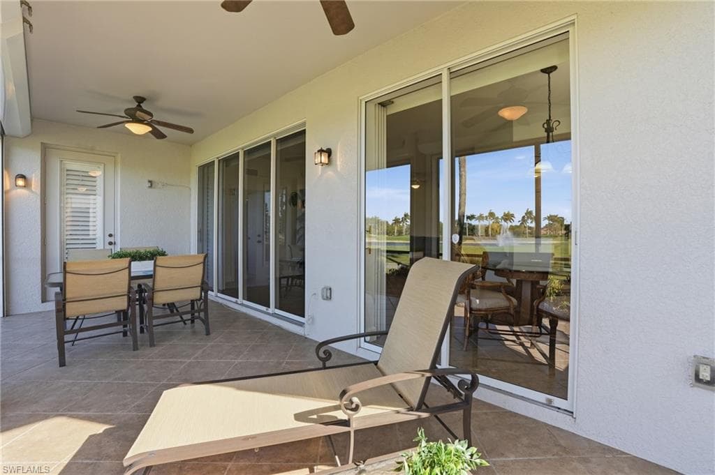 View of patio featuring outdoor dining area and a ceiling fan