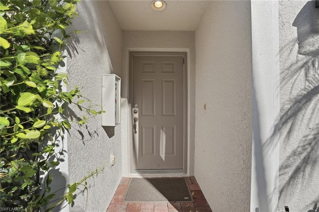 Entrance to property featuring stucco siding