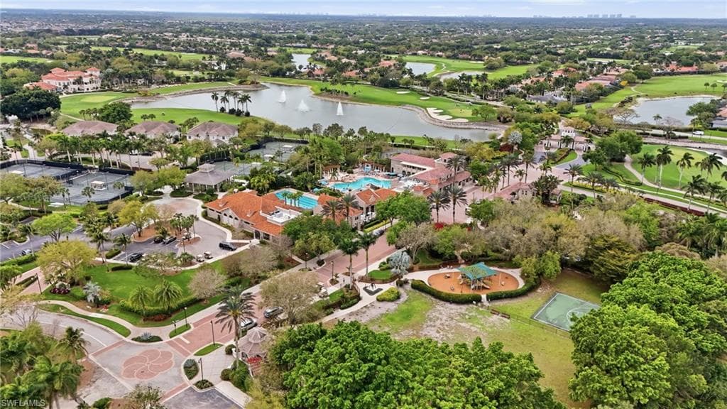 Aerial perspective of suburban area with a local golf course and a large body of water