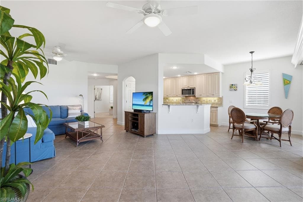 Living area featuring a ceiling fan, light tile patterned floors, and recessed lighting