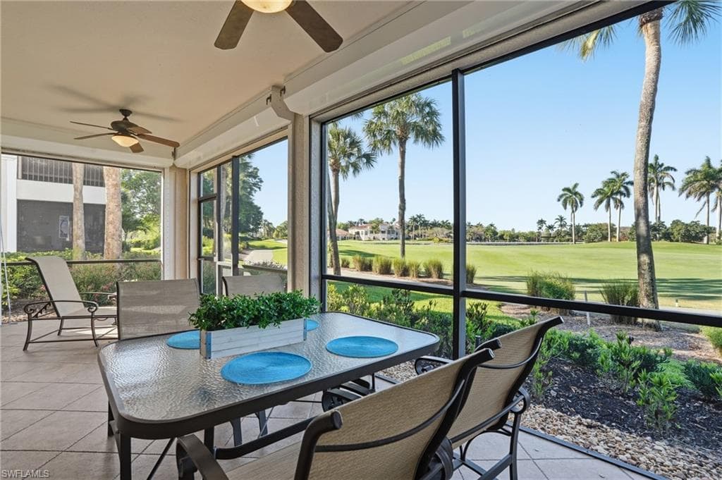 Sunroom featuring ceiling fan, outdoor dining area, and view of golf course