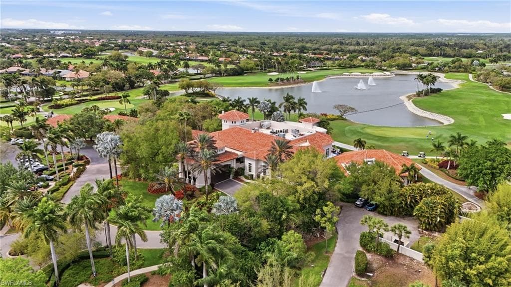 Aerial perspective of suburban area with a golf club and a nearby body of water