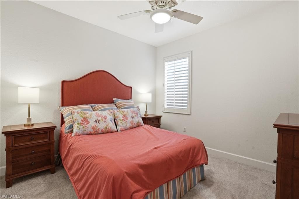 Bedroom with light colored carpet and ceiling fan