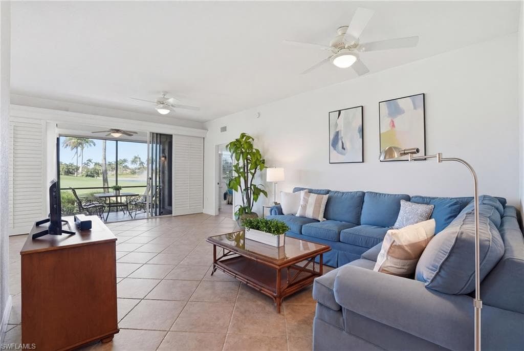 Living area featuring ceiling fan and light tile patterned floors