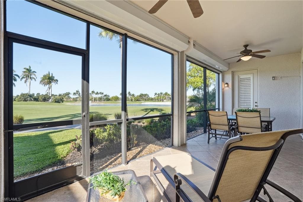 Sunroom featuring ceiling fan, outdoor dining area, and view of golf course
