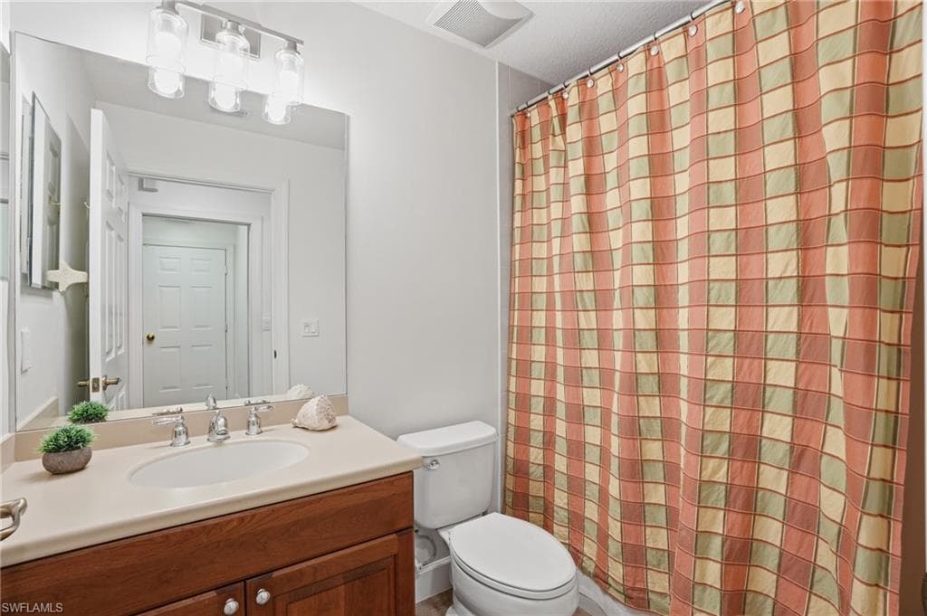 Bathroom with vanity and curtained shower