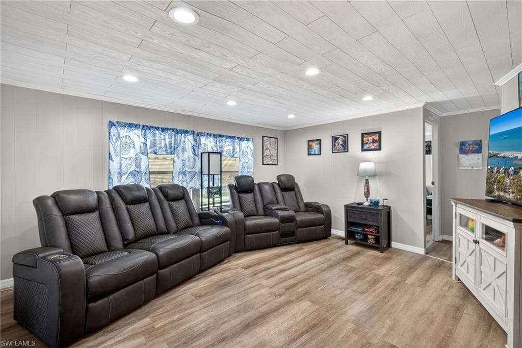 Living area featuring light wood-type flooring, recessed lighting