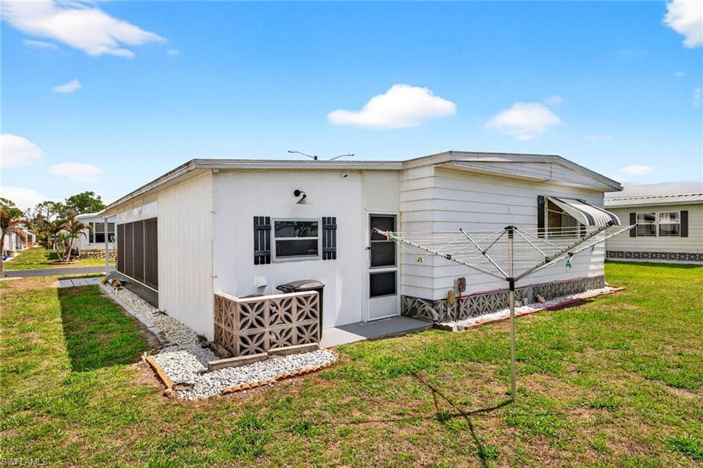 Back of property featuring a yard