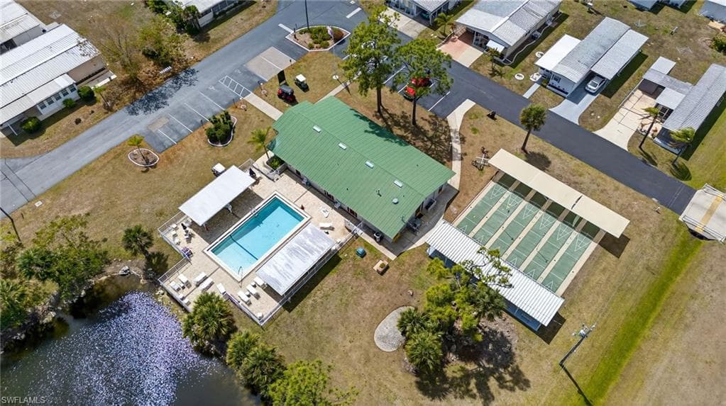 Aerial view of residential area featuring a pool