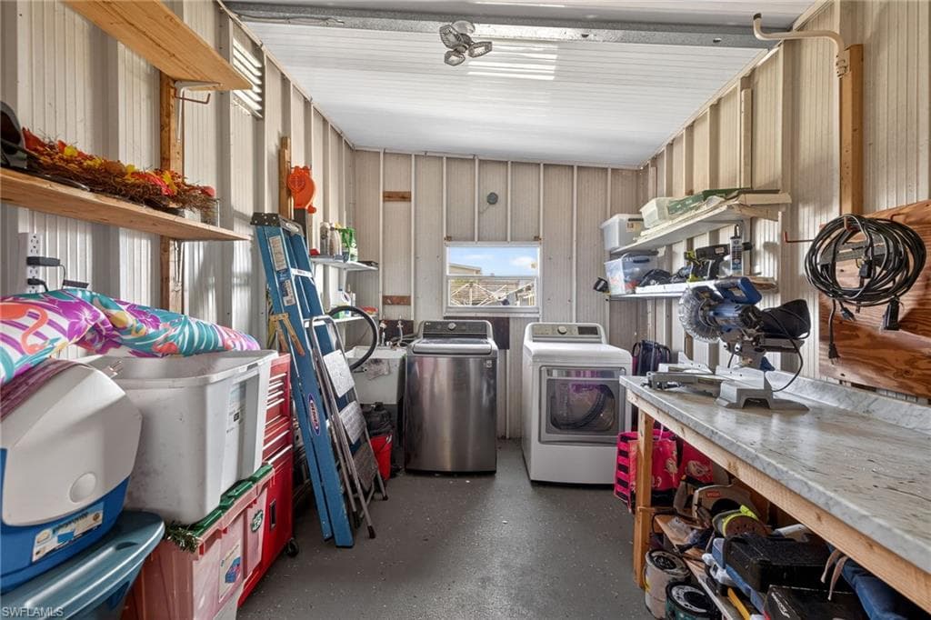 Garage featuring washer and dryer and metal wall