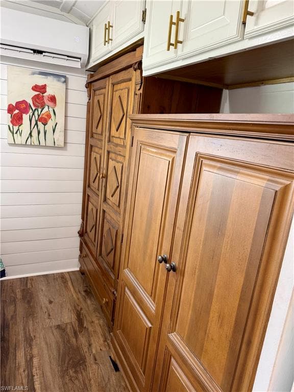Detailed view of wood finished floors, a mini split for heating / cooling, and wood walls