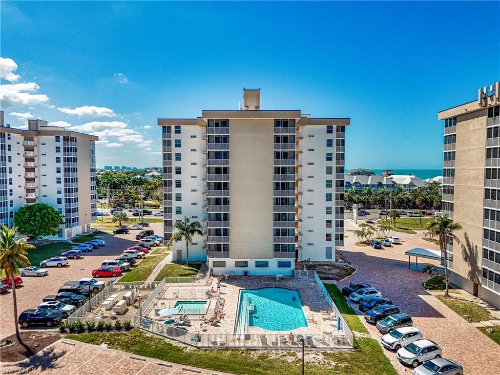 View of apartment building / complex featuring a community pool