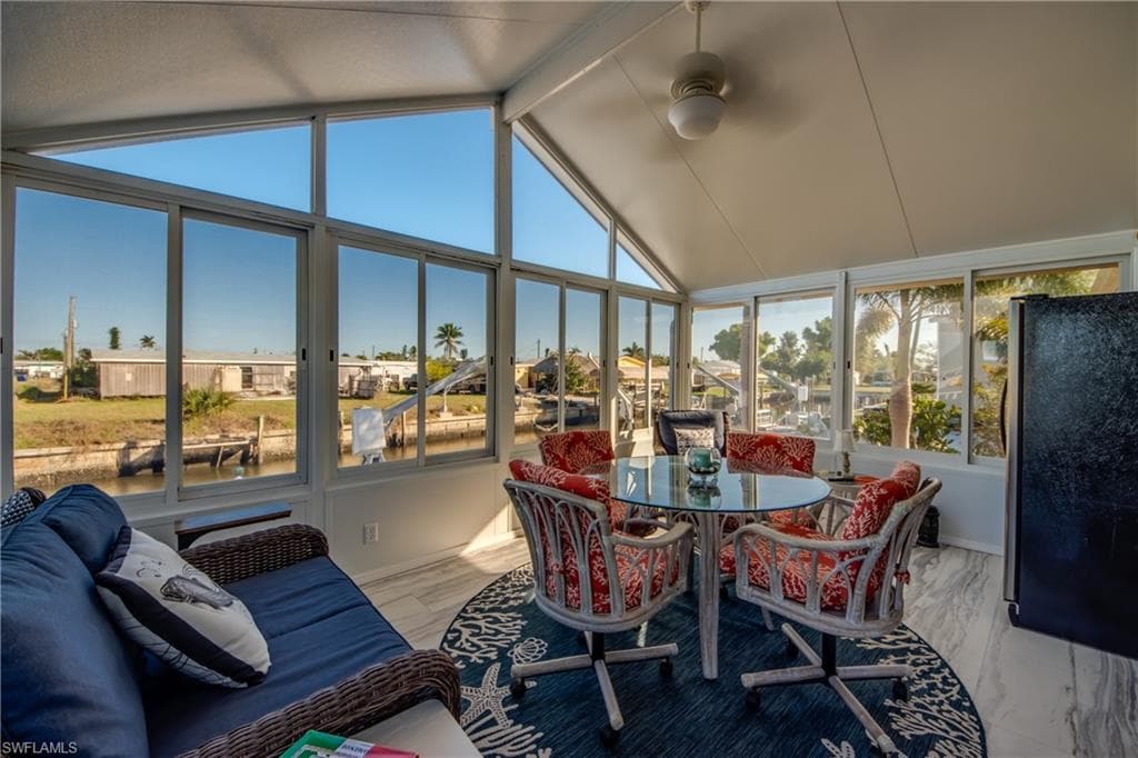 Sunroom featuring a residential view, plenty of natural light, and wood finished floors