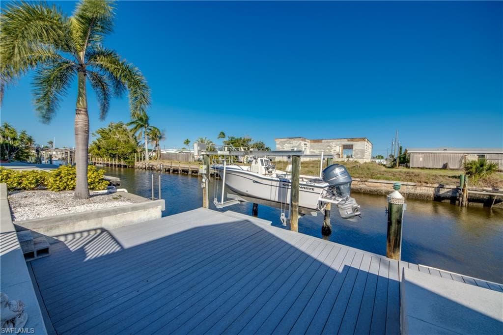 Dock with boat lift and a water view