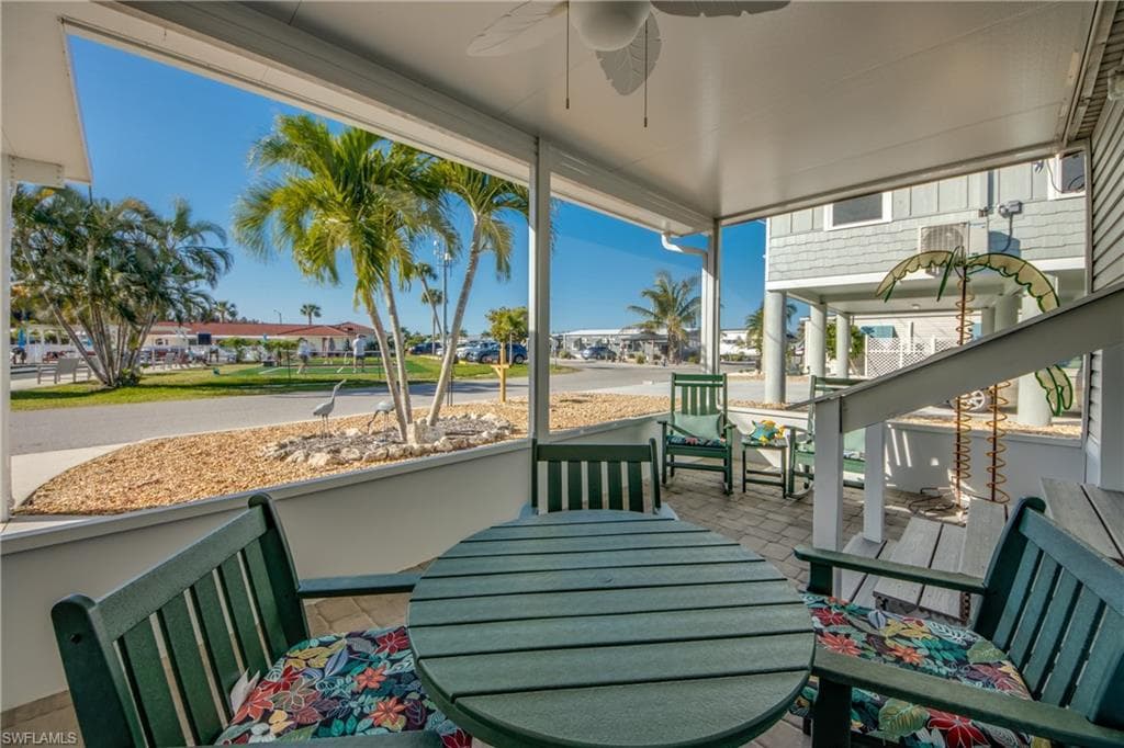 View of patio with ceiling fan, a residential view, and outdoor dining space