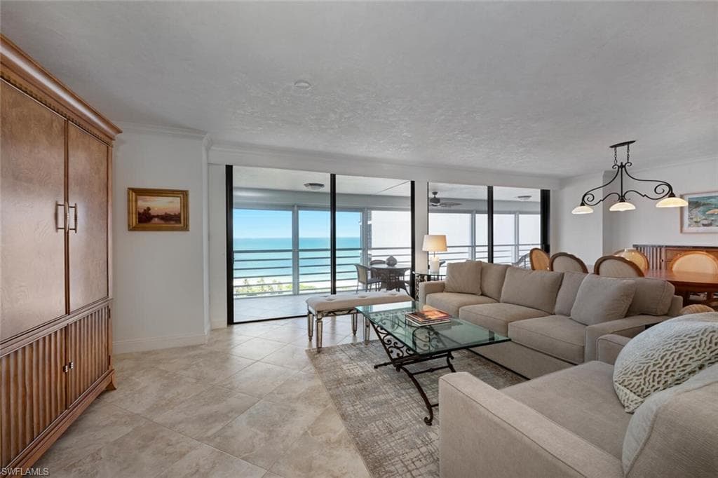 Living area with a water view and floor to ceiling windows