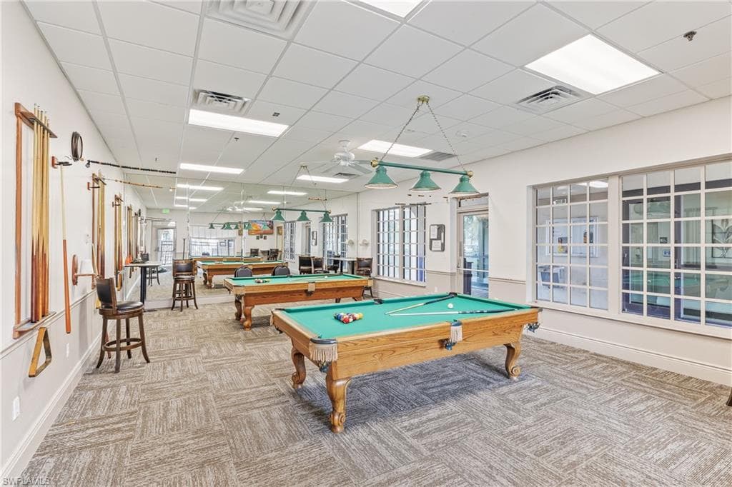Community Billard Room with a paneled ceiling, pool table, and carpet floors