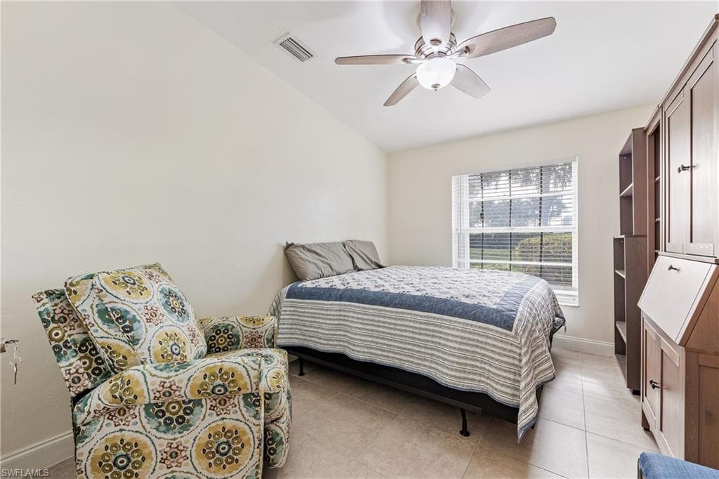 Guest Bedroom featuring ceiling fan, light tile patterned floors