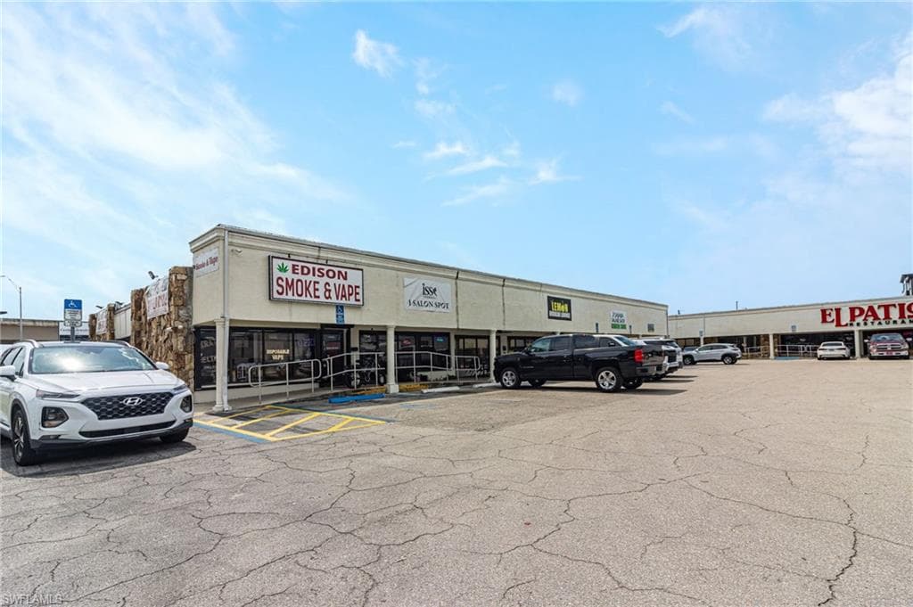 View of commercial location featuring uncovered parking