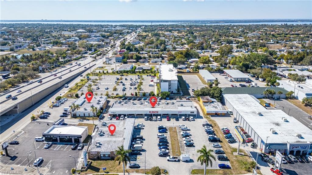 Aerial view of property's location with a commercial area