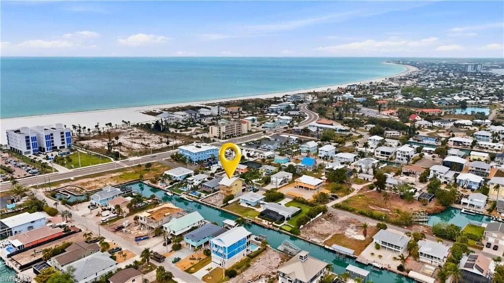 Aerial perspective of suburban area with a nearby body of water - Virtually Edited Image