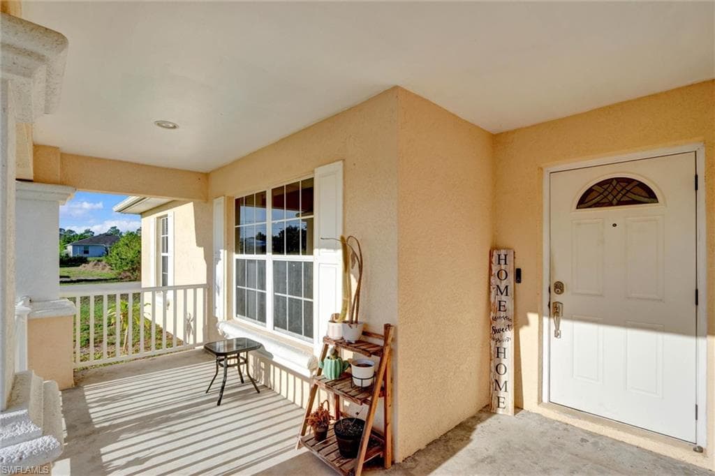 Doorway to property featuring stucco siding