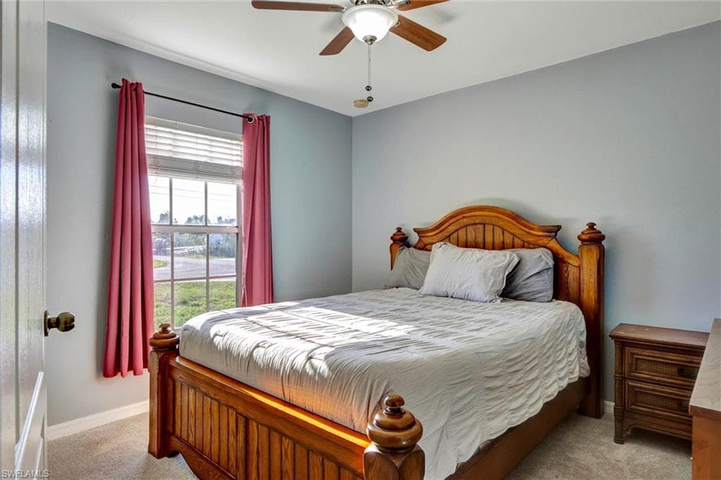 Bedroom featuring light carpet and ceiling fan