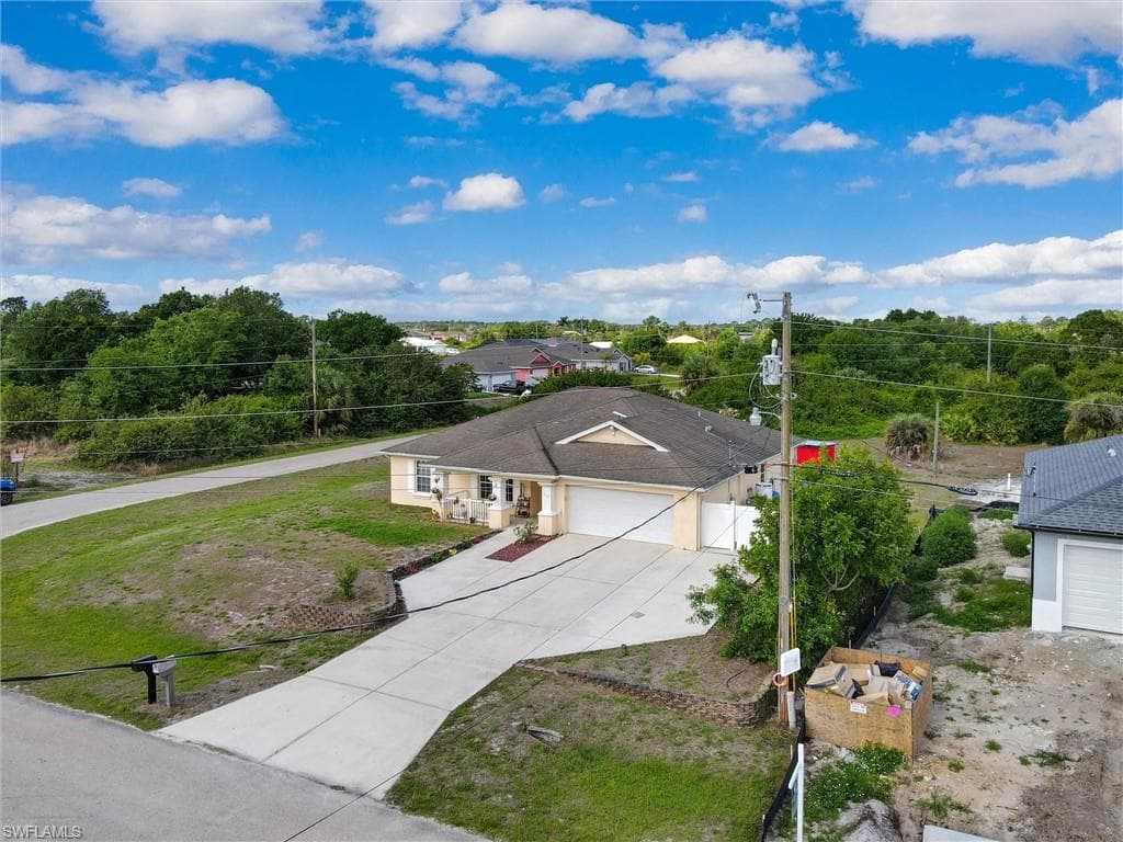 Ranch-style home with a garage and concrete driveway