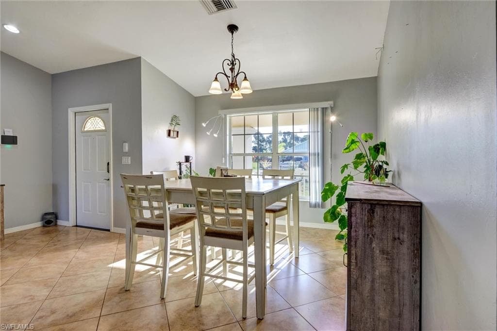 Dining area featuring a chandelier and light tile patterned floors